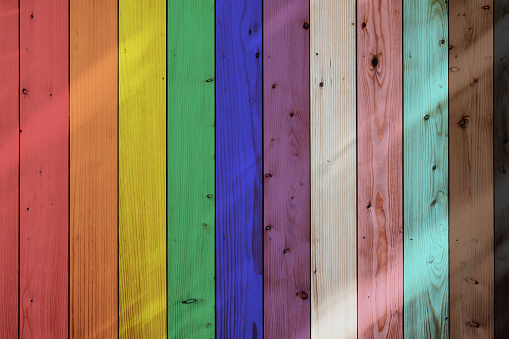 Full frame image of a wooden bench in rainbow colors.