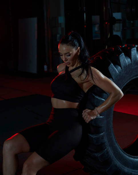 istock Woman doing training training in gym, resting leaning on truck tire. 1500122115