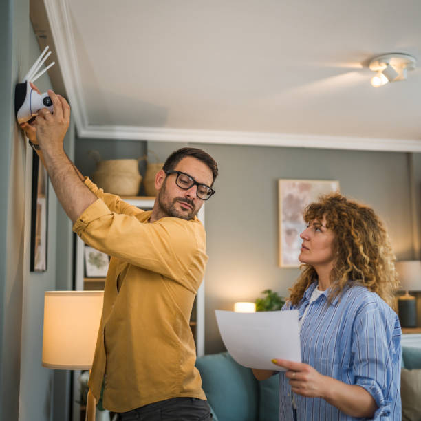 istock Couple at home connect and install cctv security surveillance camera 1500122590