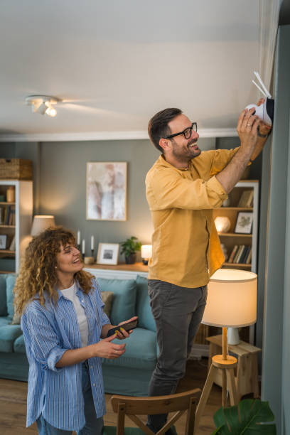 istock Couple at home connect and install cctv security surveillance camera 1500123430
