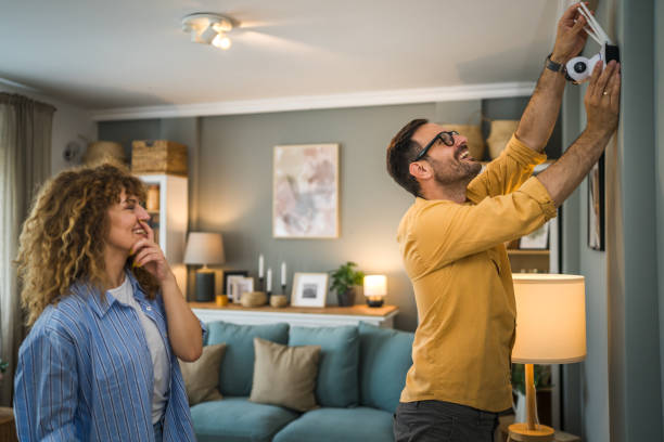 istock Couple at home connect and install cctv security surveillance camera 1500123625