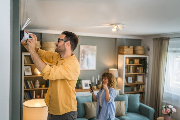 istock Couple at home connect and install cctv security surveillance camera 1500123746