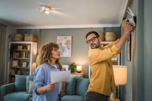 istock Couple at home connect and install cctv security surveillance camera 1500124219