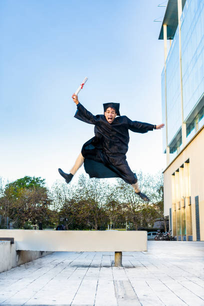 Portraits of young happy male graduate during graduation ceremony - Guatemala
