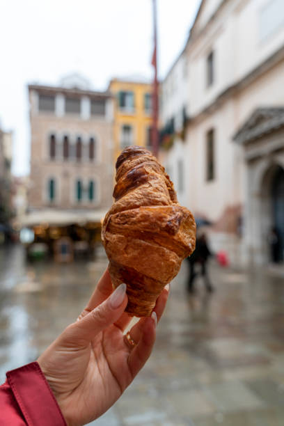 istock croissant in woman's hand 1500128926