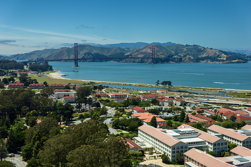 Aerial view of San Francisco, California on a sunny summer day, looking across the Marina District and Presidio towards the Golden Gate Bridge.
