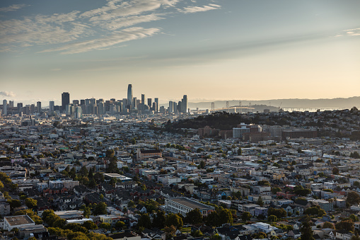 Aerial shot of San Francisco, California, looking across the city from above Bernal Heights towards the downtown skyline and the Bay Bridge at sunrise on a summer morning. This still image is part of a series; a time lapse video is also available.