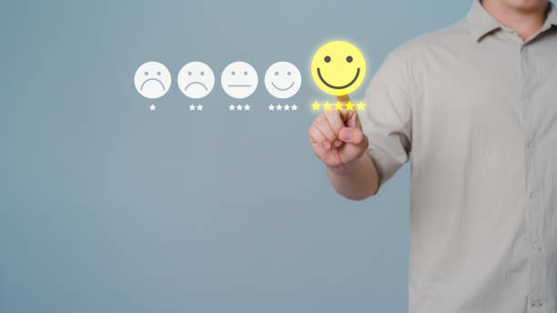 istock Assessment testimonial customer service and feedback, Opinion rating very impressed concept.Client hand are touching the virtual screen on the happy smile face icon to give satisfaction in service. 1500133894