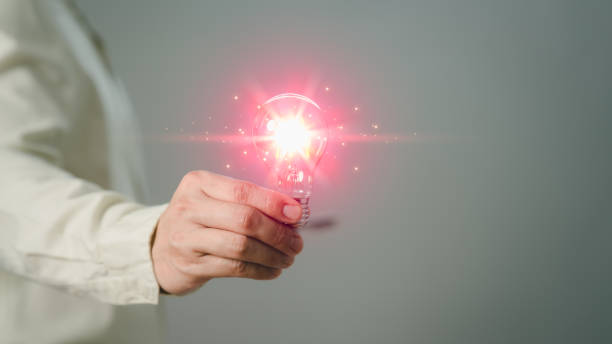 Male hand holding light bulb creative lighting with glowing light bulb Inspiring ideas for learning, technology, new knowledge and sustainable business development. Innovative ideas and inspiration.