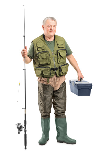 Full length portrait of a mature fisherman holding a fishing equipment isolated on white background