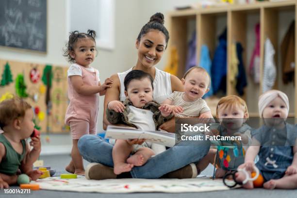 Childcareteacher With Children Stock Photo - Download Image Now - Child Care, Toddler, Baby - Human Age
