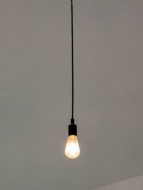 istock One single lightbulb hanging in the house. 1500149118