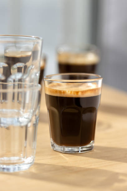 istock Three espresso coffees on a wooden board with shadow play. 1500151576