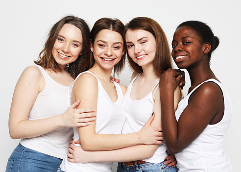 lifestyle, friendship and people concept - group of four girls friends of different nationalities