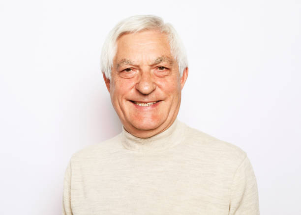 Close up portrait of happy senior man over white background stock photo