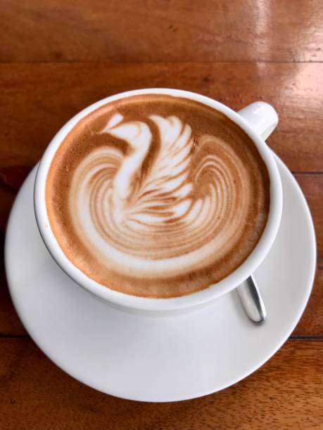 istock Hot latte in a white mug with swan design 1500169335