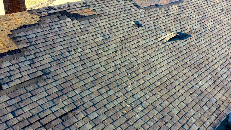 Tornado damage to roof and shingles.