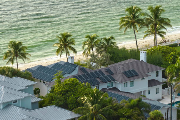 Aerial view of expensive american building roof with blue solar photovoltaic panels for producing clean ecological electric energy. Investing in renewable electricity for retirement income concept Aerial view of expensive american building roof with blue solar photovoltaic panels for producing clean ecological electric energy. Investing in renewable electricity for retirement income concept. florida real estate house home interior stock pictures, royalty-free photos & images