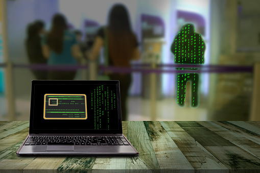 Computer with hacker Automatic Teller Machine blur background