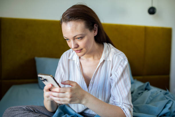 istock Young woman using a mobile phone at home 1500187028