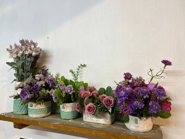 istock Pots with colorful and flower on a wood board 1500189232