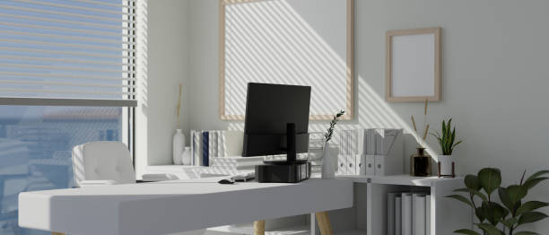 istock Interior design of a modern white office workspace in a skyscraper with a computer on a white desk 1500189759