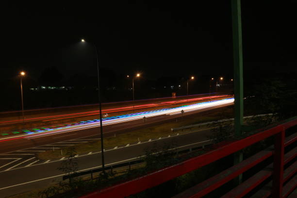 istock Colorful light trails, long time exposure motion blur effect in street 1500198586