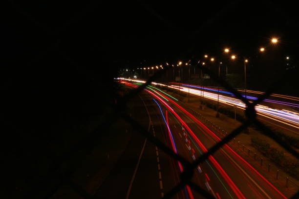istock Colorful light trails, long time exposure motion blur effect in street 1500198592