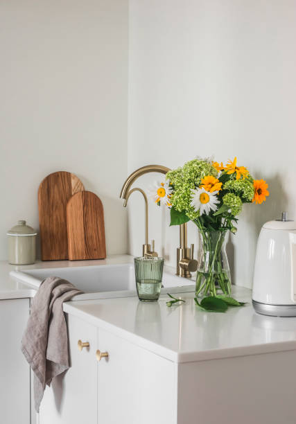 istock Cozy kitchen interior - bouquet of hydrangeas and daisies in a vase, cutting boards, kettle, kitchen utensils on the kitchen table 1500198625