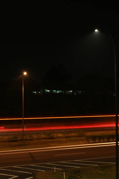istock Colorful light trails, long time exposure motion blur effect in street 1500199462