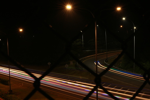 Colorful light trails, long time exposure motion blur effect in street