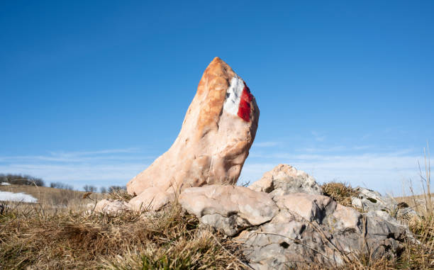 Mountain trail marking painted on a rock.