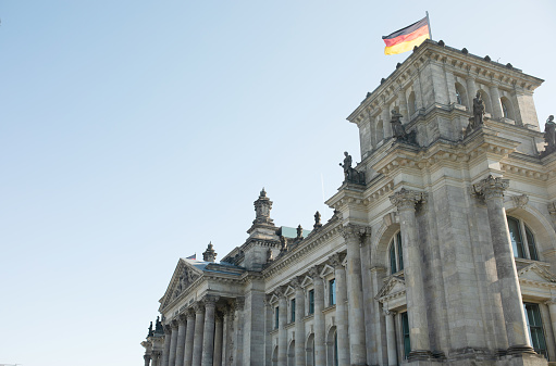 Berlin, Germany, May 2023. The Bundestag building, Parliament of the Federal Republic of Germany, with German flag flying outside.