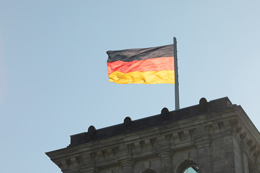 Berlin, Germany, May 2023. The Bundestag building, Parliament of the Federal Republic of Germany, with German flag flying outside.