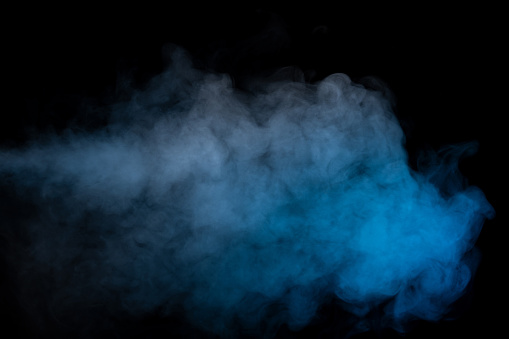 Blue and yellow steam on a black background. Copy space.