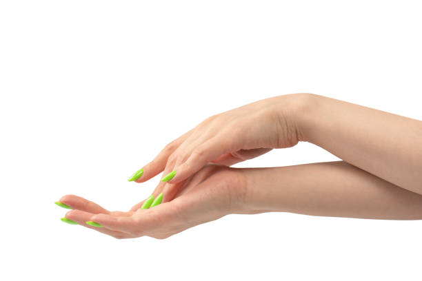 istock Hand of a woman with green naols hold some tiny or thin object. 1500211200