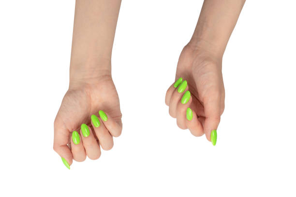 istock Hand of a woman with green naols hold some tiny or thin object. 1500211203