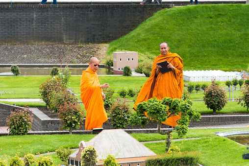 Madurodam, Netherlands - July 7, 2015: A group of Buddhist monks enjoy in Madurodam, where can appreciate the architecture of Holland in miniature.