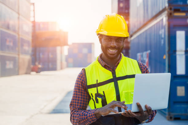 istock Logistics industry African black male engineer staff worker foreman at port container yard control loading cargo 1500213776
