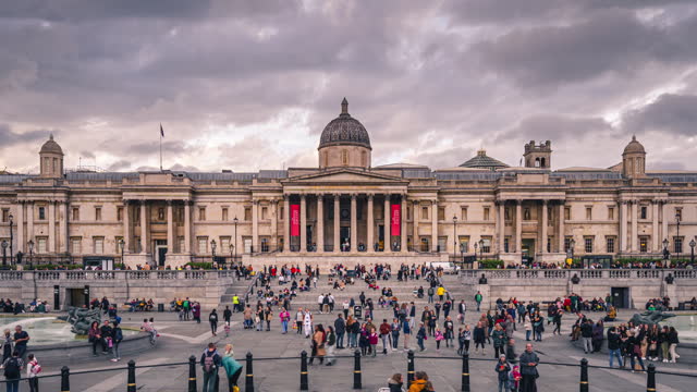 Time lapse of Crowd Traffic and Commuter Tourism people in Trafalgar Square area with national gallery London