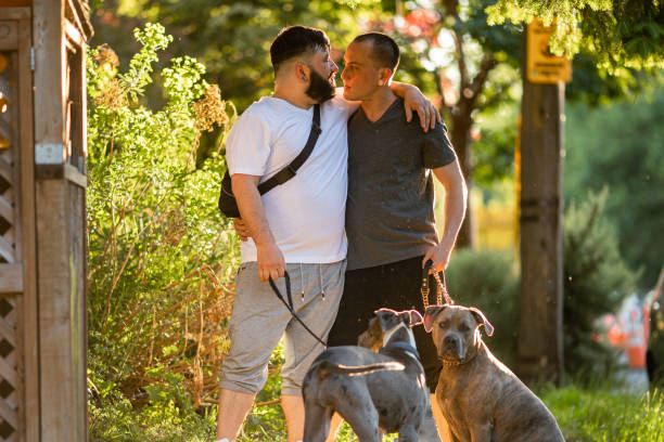 istock Two Affectionate Gay Men Walking With Their Pet Dogs 1500216924