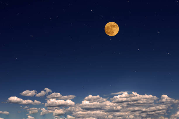 istock Strawberry full moon rising over the cloudscape 1500218834