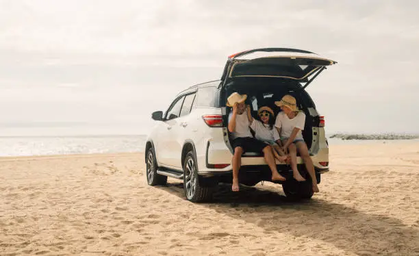 Photo of Family travel on beach, Family with car road trip at sea on summer