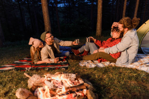 istock Young happy couples enjoying on camping during evening in the woods. 1500224698