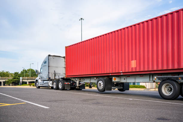 istock Gray big rig high cab semi truck with truck driver sleeping compartment transporting loaded container standing for rest on the industrial parking lot 1500225241