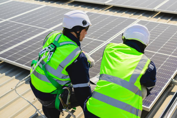 istock Engineers with safety helmet checking solar system at solar power farm 1500225292