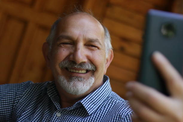 istock Senior man with smile take a selfie 1500226378