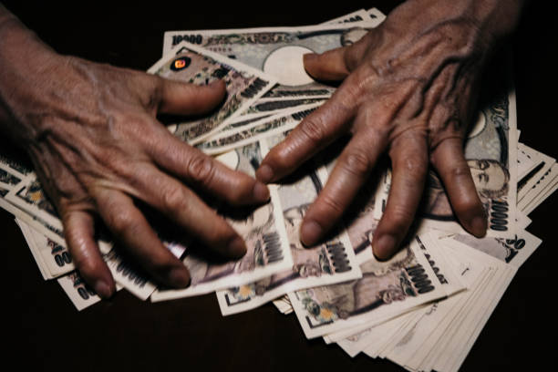 Japanese banknotes, 10,000 yen bills, elderly hands