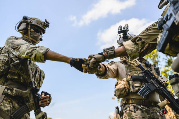 istock Squad of soldiers with teamwork stacking hands together 1500226574