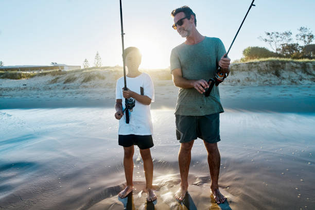 istock Father and son having a fish together after school, on an Australian beach. 1500226884